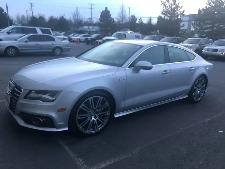 Silver sedan with repaired drivers side door and quarter panel